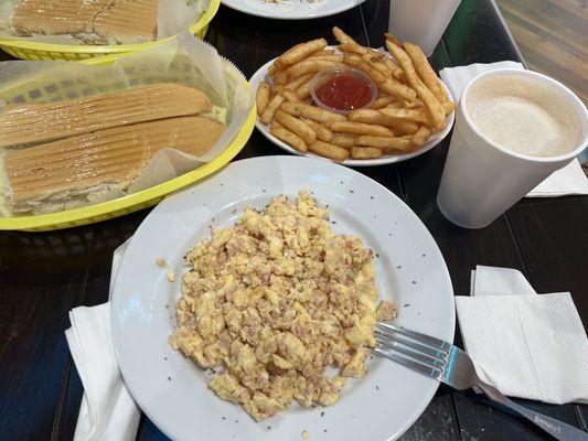 Breakfast: Scrambled eggs with ham, buttered toast, & café con leche + a side of hot crispy fries.