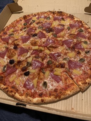 Salami, pineapple and olive pizza well done