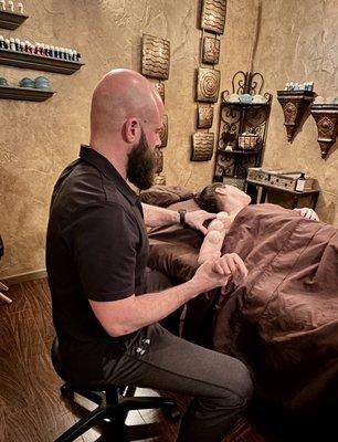 Jarrett Smilie using a cupping technique to release tension in client's bicep.