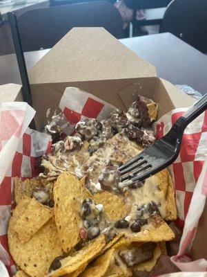 GROSS Steak Nachos with queso. AVOID the steak unless you like rubber