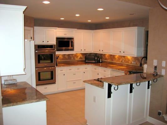 Kitchen Remodel After- Removed cabinet furdowns, glazed kitchen cabinets, venetian plaster, granite countertops, backsplash