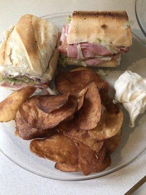 Italian sub sandwich, chips with their sauce