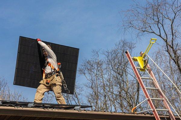 Exact Solar installers working safely on the roof, planning a new installation for a barn.