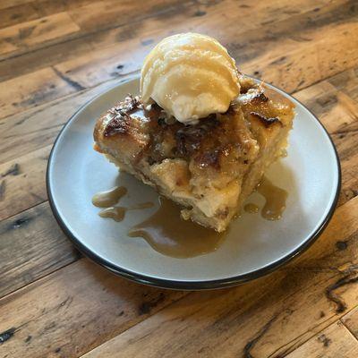 House-made apple bread pudding served ware with bourbon Carmel sauce and vanilla ice cream