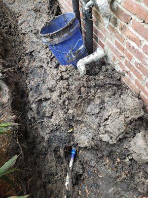 They dig a trench about 3' deep all the way to the curb, before laying in the corrugated drain pipe.