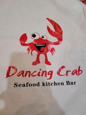 The Dancing Crab logo on a bib