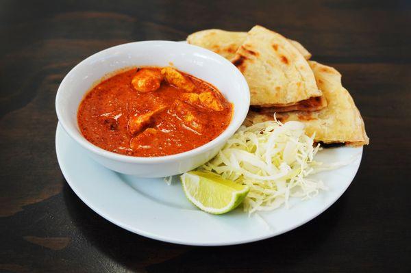 Coconut curry with your choice of veggies or chicken.  Curry is served with white cabbage lime & roti bread.