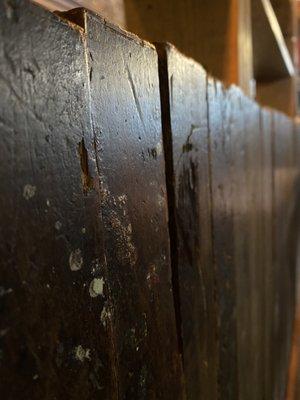 The old woodwork tht it inside the restaurant and beside the tables