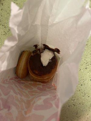 4 donuts crammed together in a bag made me upset. Look at the toppings on the bag!