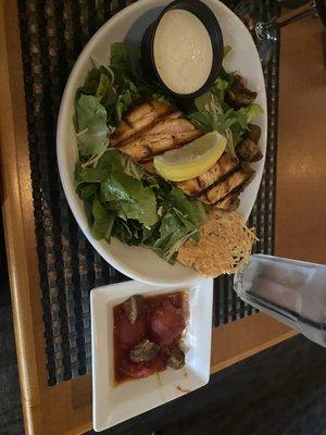 Caesar salad with salmon and a side of stewed tomatoes. Delicious!