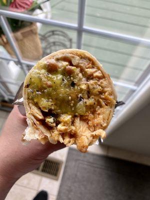 Super chicken burrito.  $10.91 total. Salsa verde poured on before biting in. So good.