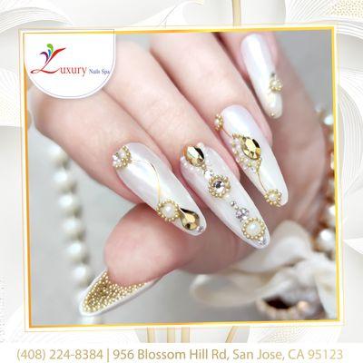 Experience the epitome of sophistication with our luxurious white and gold nail design - a timeless fusion of elegance and glamour!