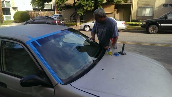 Chris finishing up replacing my 98 corolla windshield!