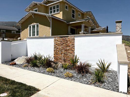 Water feature with Santa Barbara stucco finished . Plants 
Lighting and more