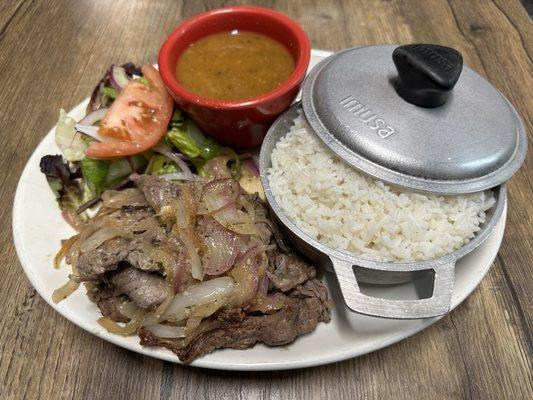 Then sliced sirloin, steak, caramelized onions with rice, red beans, and a side salad with a housemaid passionfruit vinaigrette