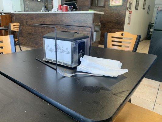 Table with dirty fork and napkins (does not reflect the rest of the restaurant which was very clean)