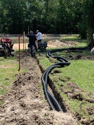 Us installing the French drain to go into pond.