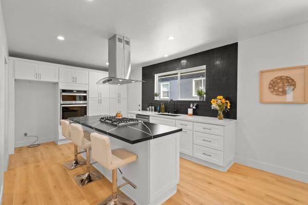 Pencil Tiles, Silestone, farmhouse sink, and an island stove top