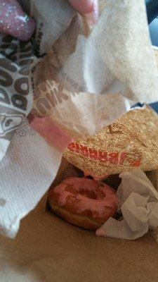 This is how my donut was in my bag I was so appalled and upset that I had to take a picture of it frosting went everywhere