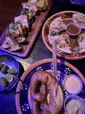 Pretzel, quesadilla, olives, and grilled Brie cheese