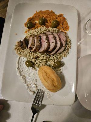 Special with pork loin, tziaki sauce, hummus, with cous cous