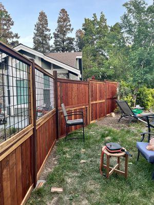 6' Redwood Fence between the houses, 3' Hog Wire and 3' Redwood looking into street.