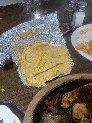 Asked for more tortillas and this is what they gave me. All old and sweaty and broken tortillas.  This is sad coming from a Mexican