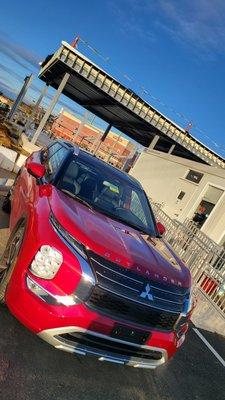 The New 2023 Mitsubishi sitting infront of the New 2023 Renn Kirby Mitsubishi building coming April 2023