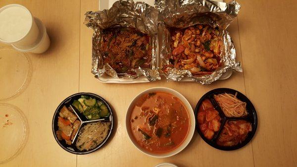 Takeout: marinated spicy sliced pork, spicy squid stir fry, spicy kimchi soup and side dishes