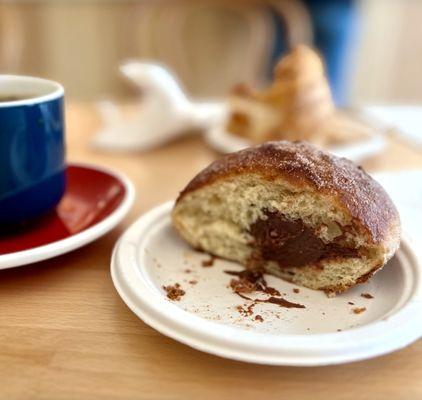 Bombolone dusted with cocoa sugar and filled with rich chocolate Cremeux