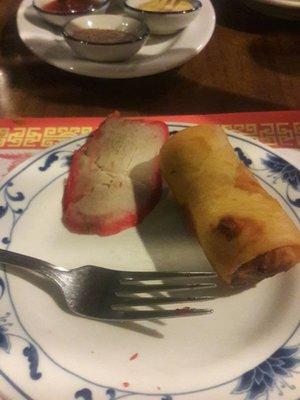 Somewhat tasty egg roll and cold, hard barbeque pork.