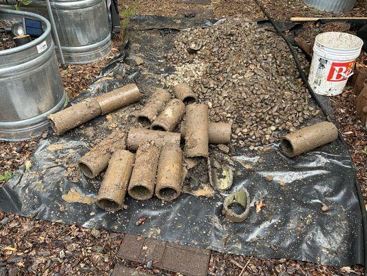 They unearthed our problem.  Concrete pipe sections that leaked and filled the ground around the foundation with roof runoff.