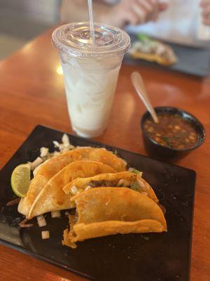 Birria taco, quesabirria and horchate. Asada taco im the background.