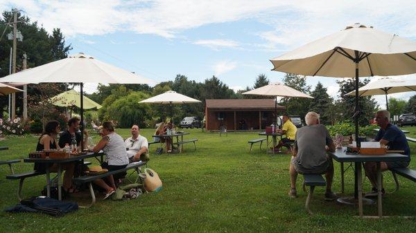 Guests sitting on the grounds, listening to live music.