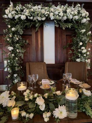 Sweetheart table and flower arch