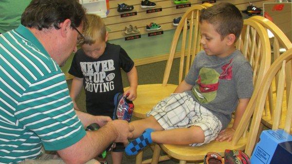 Rick helping fit my nephew's extra wide feet! End result, a perfect fit!