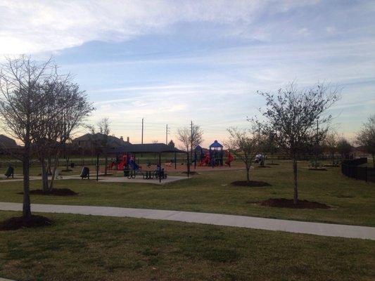 Nice playground with big a little kid's side, covered picnic tables and plenty of seating for adults, also a nice trail around pond