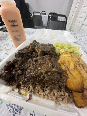 Oxtail plate Large with red beans and rice, Plantains, and Steamed Veggies. Got the homemade carrot juice