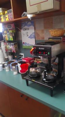 Self serve coffee area with cool cream or 2% milk machine.