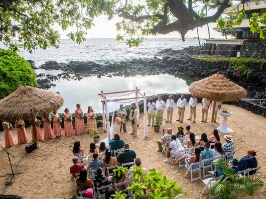 Wedding ceremony at private sandy cove and saltwater lagoon with the Pacific Ocean in the background