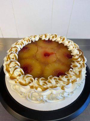 A GORGEOUS Pineapple Upside Down Cake finished with Vanilla Buttercream Rosettes and homemade Salted Caramel Swirl