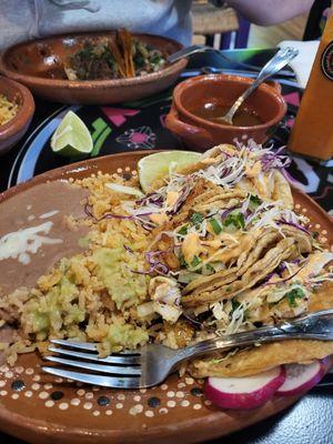 My fish tacos with the green sauce on the rice.