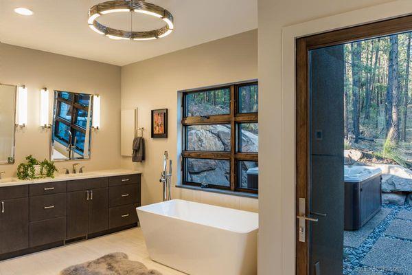 Master Bathroom with Quartz Countertops and Modern Chandelier.