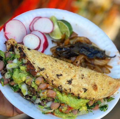 TACO PLACOSO IS TOPPED WITH BEANS