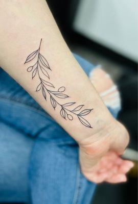 delicate olive branch tattoo by Ralph at Emerald Tattoo Roseville