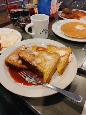 Nice size French toast with egg bread. Moist center with warm butter and raspberry syrup.