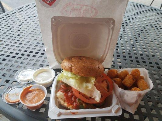 Siracha grilled chicken "burger" with tater tots. Yum.