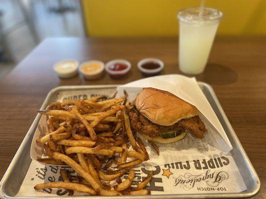 Simple chicken sandwich, Cajun fries, lemonade and sauces line up