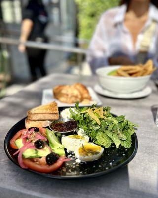 Middle Eastern Breakfast | cucumbers, tomatoes, pickled onion, egg, herb salad, labneh, feta, za'atar, lemon, olives, fig jam, sourdough