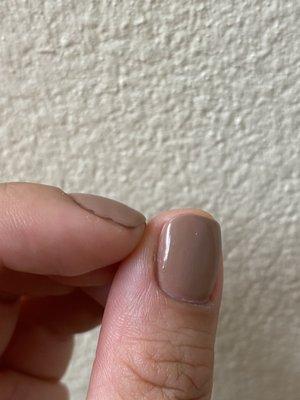 Bubbles and dirt in nail. Patchy application on the sides.